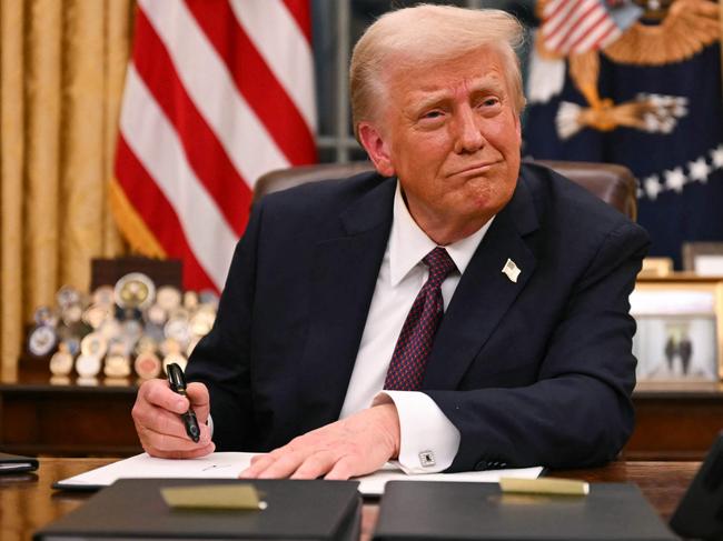 US President Donald Trump signs executive orders in the Oval Office of the White House in Washington, DC, on January 20, 2025. Picture: NewsWire / Jim WATSON / POOL / AFP