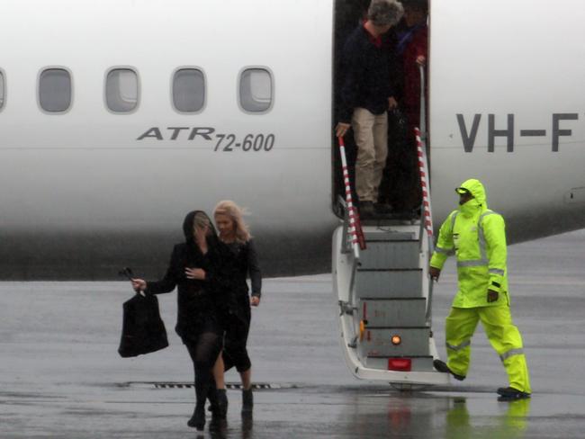 21/04/15 Sydney, NSW Â© Andrew Murray Planes delayed at Sydney Domestic Airport. Passengers having to walk in the rain when arriving back into Sydney