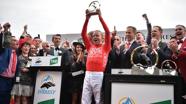 Winning jockey Kerrin McEvoy with The Everest trophy which is worth almost half a million dollars. Picture: AFP Photo/Peter Parks