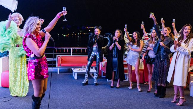 Kate Adams makes her own birthday toast after Krissy Marsh steals the microphone from the drag queen host. Picture: Binge