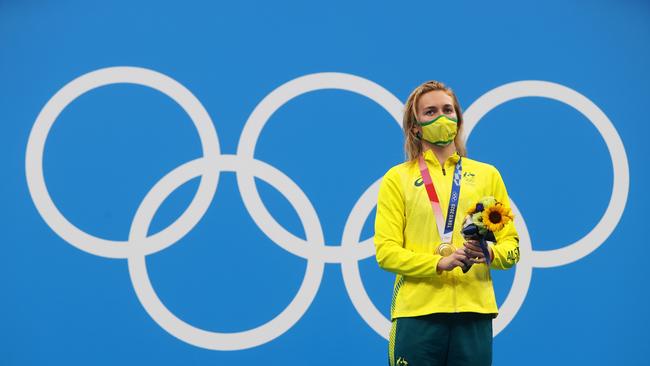 Titmus poses with the gold medal on the podium. Picture: Clive Rose/Getty Images.