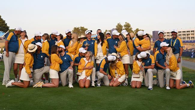 Players of Team Europe and their partners pose for a photograph with the Ryder Cup trophy following their victory in Rome. Picture: Ross Kinnaird/Getty Images