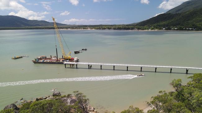 A dinghy carrying construction workers comes across to Yarrabah from the other side of the inlet. Picture: Brendan Radke