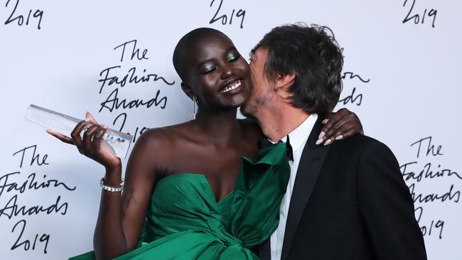 Akech poses for a photograph with award presenter Pier Paolo Piccioli after winning the Model of the Year Award at the The Fashion Awards in London in December, 2019. Photo Isabel Infantes / AFP.