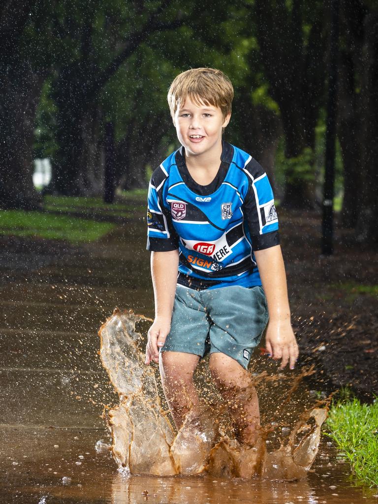 Winston McBride has fun jumping in puddles in the rain in Toowoomba's Queens Park, Saturday, January 8, 2022. Picture: Kevin Farmer