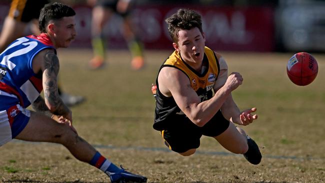 WRFL: Werribee Districts’ Harrison White fires out a flying handball. Picture: Andy Brownbill