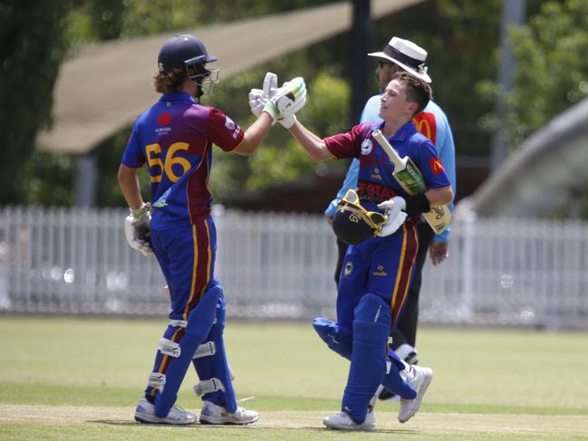 Zach Haddin (R) is congratulated by Joshua McDowell after reaching his century. Picture Warren Gannon Photography