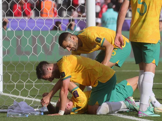 Australia's forward #06 Martin Boyle (bottom) celebrates with teammates after scoring his team's second goal during the Qatar 2023 AFC Asian Cup football match between Australia and Indonesia at the Jassim bin Hamad Stadium in Doha on January 28, 2024. (Photo by Giuseppe CACACE / AFP)