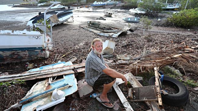 Debbie left an apocalyptic scene at ground zero. Above, Stuart Harris at Shute Harbour with his home and wrecked boat. Photo: Annette Dew