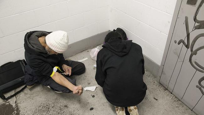 People seen injecting heroin in a carpark in Little Collins St. Picture: Ian Currie