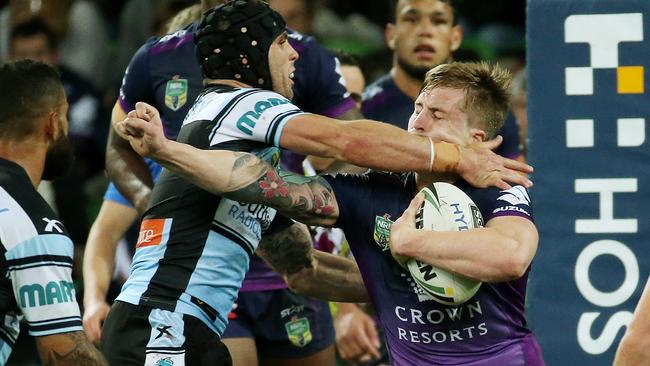 Cameron Munster cops a high shot from Michael Ennis. Picture: Colleen Petch.