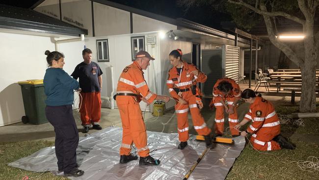 SES crews learn how to roll a tarp to be flung over a roof in a safe way, removing the need for volunteers to get on roofs during storms and wild weather. Picture: Tara Miko