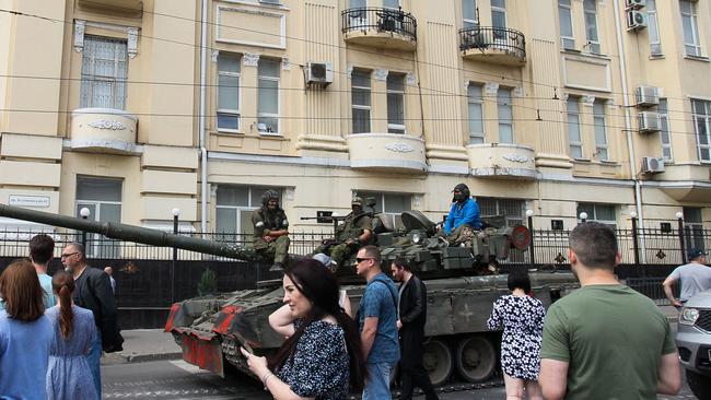 Wagner Group fighters sit atop of a tank in a street in the city of Rostov-on-Don on Saturday. Picture: AFP