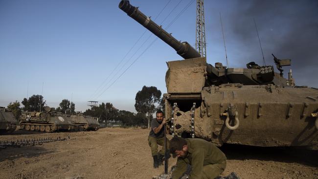 Israeli soldiers fix tank tracks near the border with Gaza. Picture: Getty Images