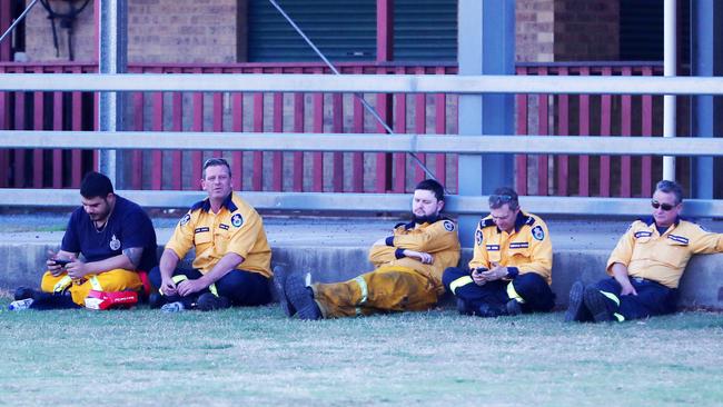 Volunteer firefighters take a moment to rest between shifts as fires ravage the Canungra and Sarabah regions. Picture: Nigel Hallett.