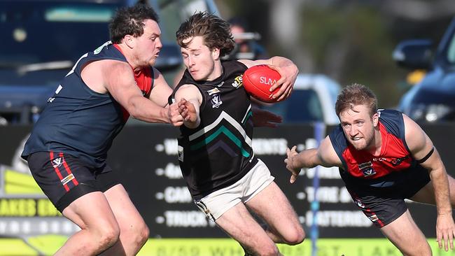 Swifts Creek’s Andrew Sandy wraps up William Cook of Omeo-Benambra. Picture: Yuri Kouzmin