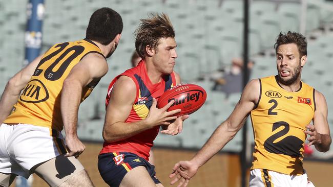 Sam Colquhoun under pressure from Blaine Johnson and Shane Nelson in last year’s SANFL v WAFL clash. Picture SARAH REED