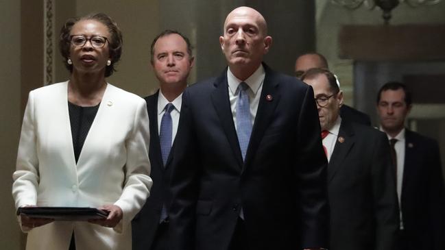 US House Sergeant at Arms Paul Irving and House clerk Cheryl Johnson hold the two impeachment articles as they lead the seven impeachment managers to the Senate chamber of the US Capitol.