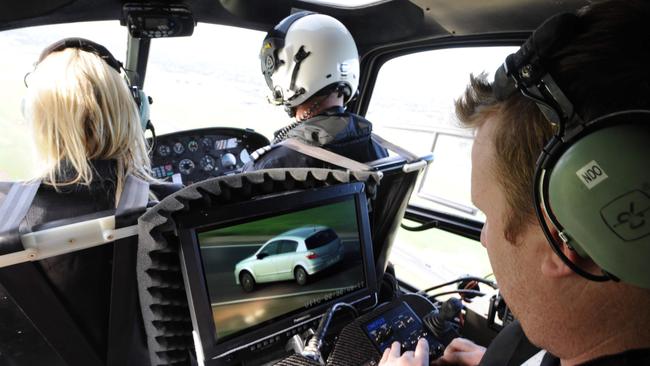 Tomlinson at work inside a helicopter.