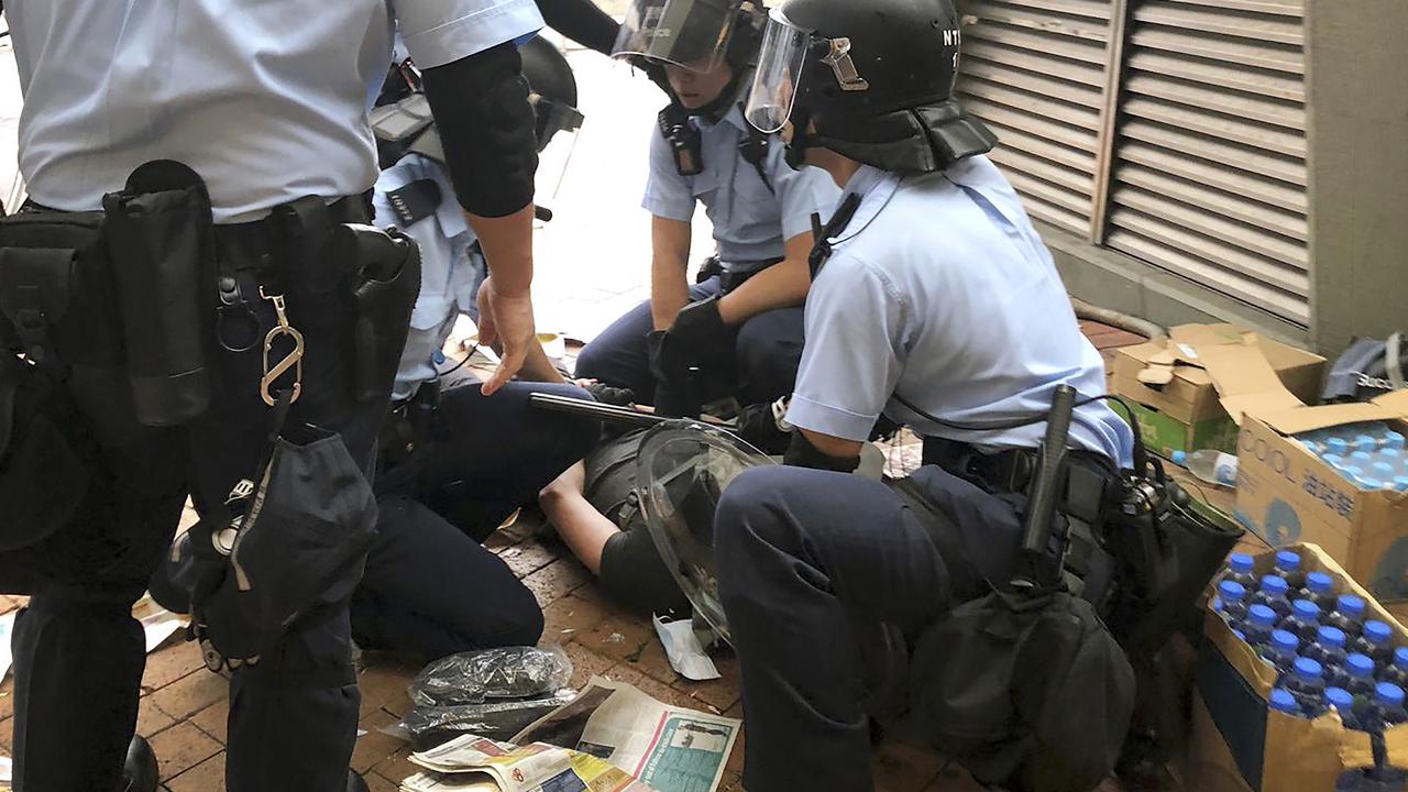 Riot policemen detain a protester near the Legislative Council. Picture: Kin Cheung/AP