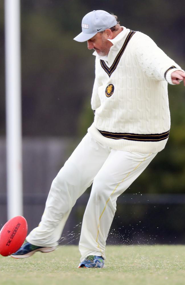 Gary Ablett Snr has a kick while waiting for the rain to pass. Picture: Alex Coppel