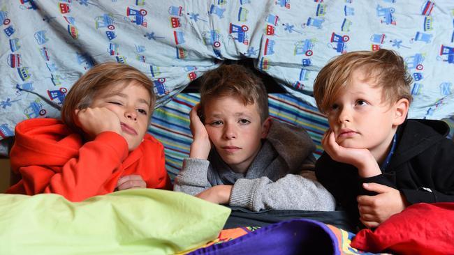 Bored brothers Charlie, 10, Luis, 12, and Felix Bettinsoli, 7. Picture: Josie Hayden