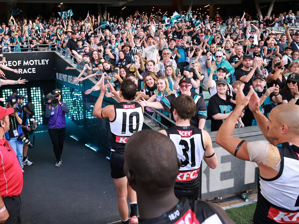 Milestone man Travis Boak leads the Power off the ground. Picture: James Elsby/AFL Photo