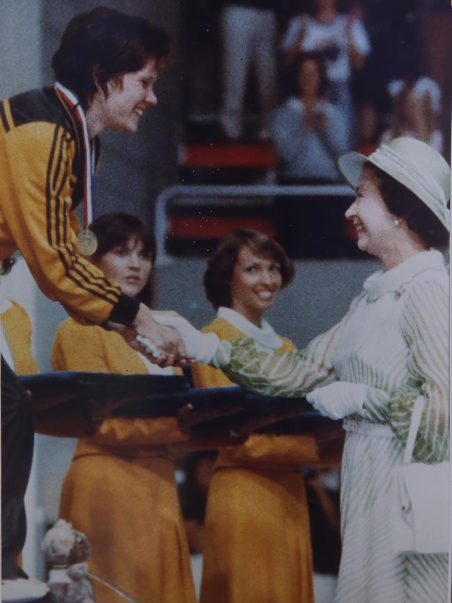 Teen swimming sensation from the 1982 Commonwealth Games in Brisbane, Tracey Wickham being presented with her gold medal for the 400m freestyle, by Queen Elizabeth during the games