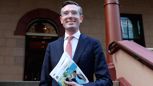 NSW Treasurer Dominic Perrottet holding the budget outside Parliament House in Sydney. Picture: NCA NewsWire / Dylan Coker