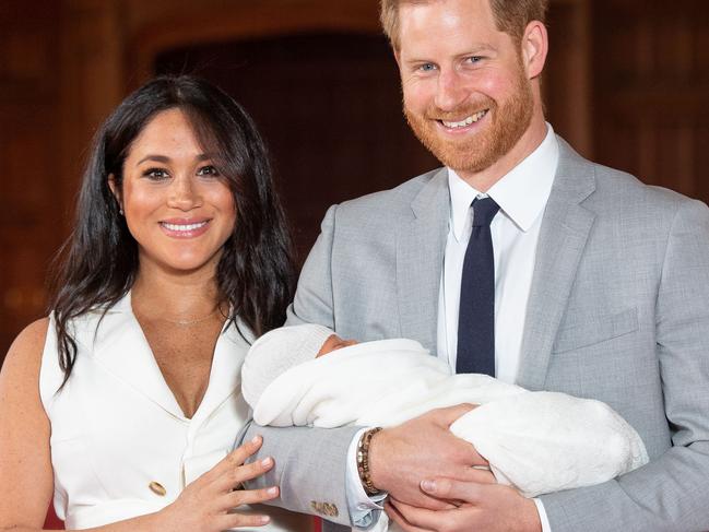 (FILES) In this file photo taken on May 08, 2019 Britain's Prince Harry, Duke of Sussex (R), and his wife Meghan, Duchess of Sussex, pose for a photo with their newborn baby son, Archie Harrison Mountbatten-Windsor, in St George's Hall at Windsor Castle. - Prince Harry and his wife Meghan's new home in Windsor cost £2.4 million ($3.05 million, 2.7 million euros) of taxpayers' money to renovate, royal accounts showed on June 25, 2019, prompting criticism from anti-monarchy campaigners. (Photo by Dominic Lipinski / POOL / AFP)