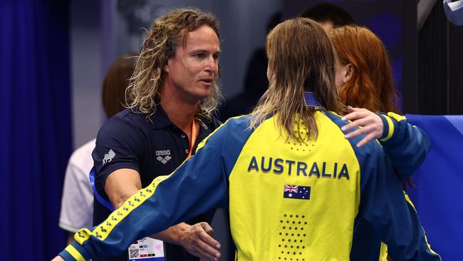 Australian swim coach Dean Boxall hugs O'Callaghan and Titmus. Picture: Clive Rose/Getty Images