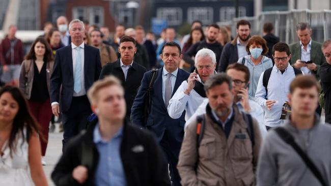 Commuters walk across London Bridge toward the City of London. Picture: AFP.