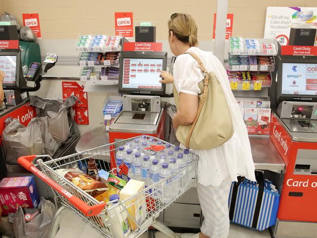 a Customer uses the self serve checkout at Coles Erina - Theft from retail stores across the Coast up about 20% Picture by Mark Scott