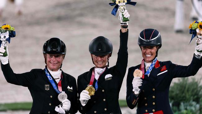 Silver medallist Germany’s Isabell Werth, gold medallist Germany’s Jessica von Bredow. Werndl and bronze medallist Britain’s Charlotte Dujardin. Photo by Behrouz MEHRI / AFP)