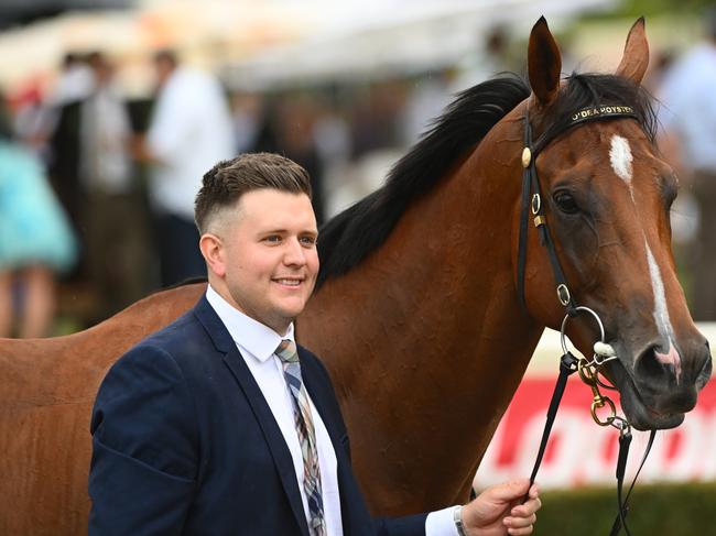 MELBOURNE, AUSTRALIA - FEBRUARY 25: Trainer Matthew Hoysted poses with Uncommon James after winning Race 9, the Ladbrokes Oakleigh Plate,  during Melbourne Racing at Sandown Lakeside on February 25, 2023 in Melbourne, Australia. (Photo by Vince Caligiuri/Getty Images)