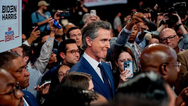 Gavin Newsom and a group of fellow democrats speak to reporters in the spin room following the debate. Picture: Getty Images via AFP.