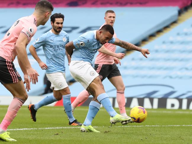 Manchester City's Brazilian striker Gabriel Jesus (3L) scores the opening goal during the English Premier League football match between Manchester City and Sheffield United at the Etihad Stadium in Manchester, north west England, on January 30, 2021. (Photo by Martin Rickett / POOL / AFP) / RESTRICTED TO EDITORIAL USE. No use with unauthorized audio, video, data, fixture lists, club/league logos or 'live' services. Online in-match use limited to 120 images. An additional 40 images may be used in extra time. No video emulation. Social media in-match use limited to 120 images. An additional 40 images may be used in extra time. No use in betting publications, games or single club/league/player publications. /