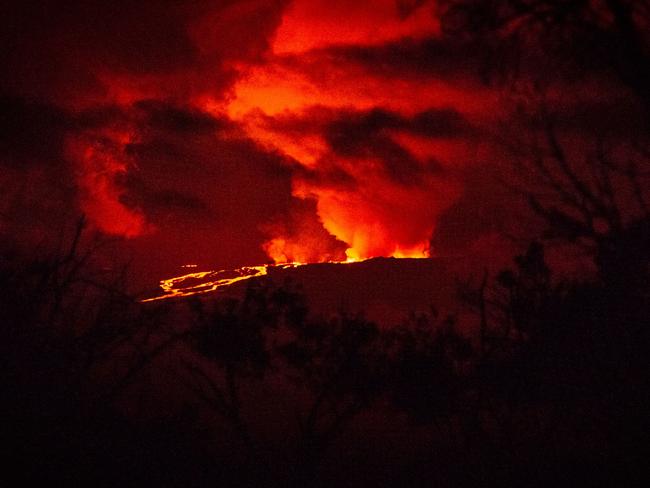 Rivers of molten rock could be seen high up on the volcano, venting huge clouds of steam and smoke at the summit on Big Island. Picture: AFP.