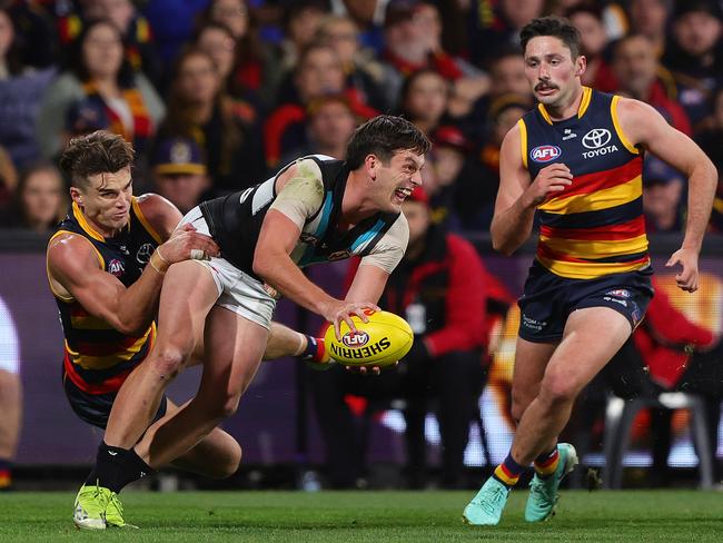 Zak Butters is caught by Crow Ben Keays on Thursday night. Picture: Sarah Reed/AFL Photos