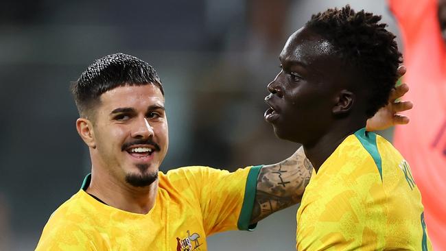 SYDNEY, AUSTRALIA - MARCH 24: Garang Kuol (r) of the Socceroos celebrates with Marco Tilio of the Socceroos after scoring a goal during the International Friendly match between the Australia Socceroos and Ecuador at CommBank Stadium on March 24, 2023 in Sydney, Australia. (Photo by Mark Kolbe/Getty Images)