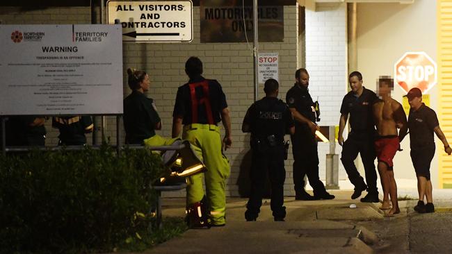 Police escorting a teenager after a  riot and fire at Don Dale Detention Centre.  Picture: Keri Megelus