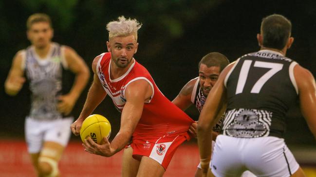 Waratah’s Will Collis looks to get the ball away in his side’s 2021-22 NTFL season opener against Palmerston at Gardens Oval on Friday night. Picture: Glenn Campbell