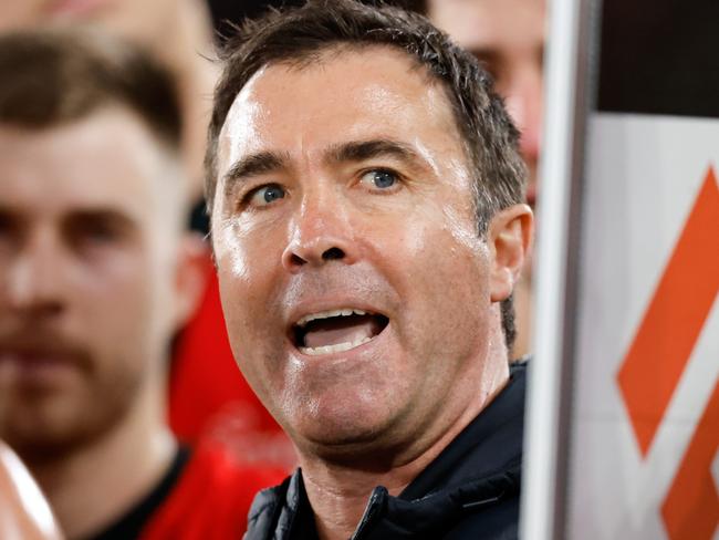 MELBOURNE, AUSTRALIA - AUG 16: Brad Scott, Senior Coach of the Bombers addresses his players during the 2024 AFL Round 23 match between Essendon Bombers and the Sydney Swans at Marvel Stadium on August 16, 2024 in Melbourne, Australia. (Photo by Dylan Burns/AFL Photos via Getty Images)