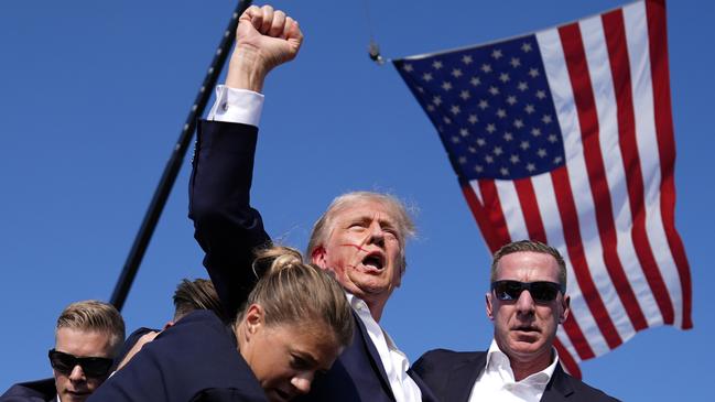 Republican presidential candidate, former President Donald Trump, reacted bravely, with a defiant and bloodied fist pump, to being struck in the ear by the bullet of a would-be-assassin. Picture: AP Photo/Evan Vucci