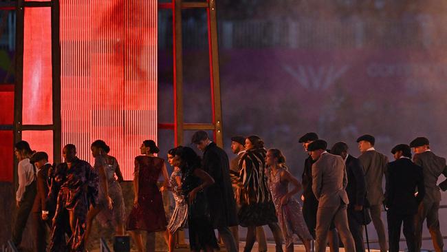 British singer Laura Mvula (L) performs with Peaky Blinders-themed dancers.