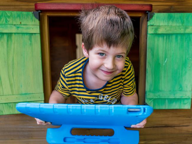 Zeke Nicholson, 6, talks to friends and family members on his iPad during the coronavirus pandemic. Picture: Jennifer Dudley-Nicholson