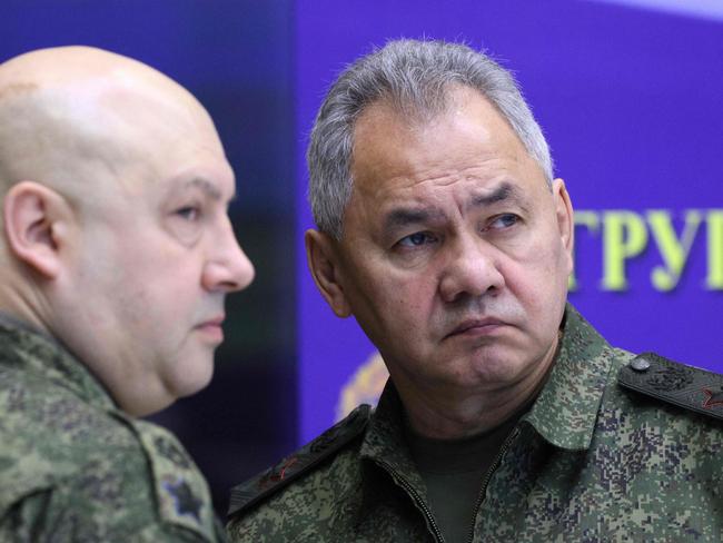 Russian General Sergei Surovikin (L), commander of Russia's military operation in Ukraine and Russian Defence Minister Sergei Shoigu (R) are pictured during a visit of Russian President to the joint staff of troops involved in Russia's military operation in Ukraine in an undisclosed place on December 17, 2022. (Photo by Gavriil GRIGOROV / Sputnik / AFP) / *Editor's note : this image is distributed by Russian state owned agency Sputnik.*