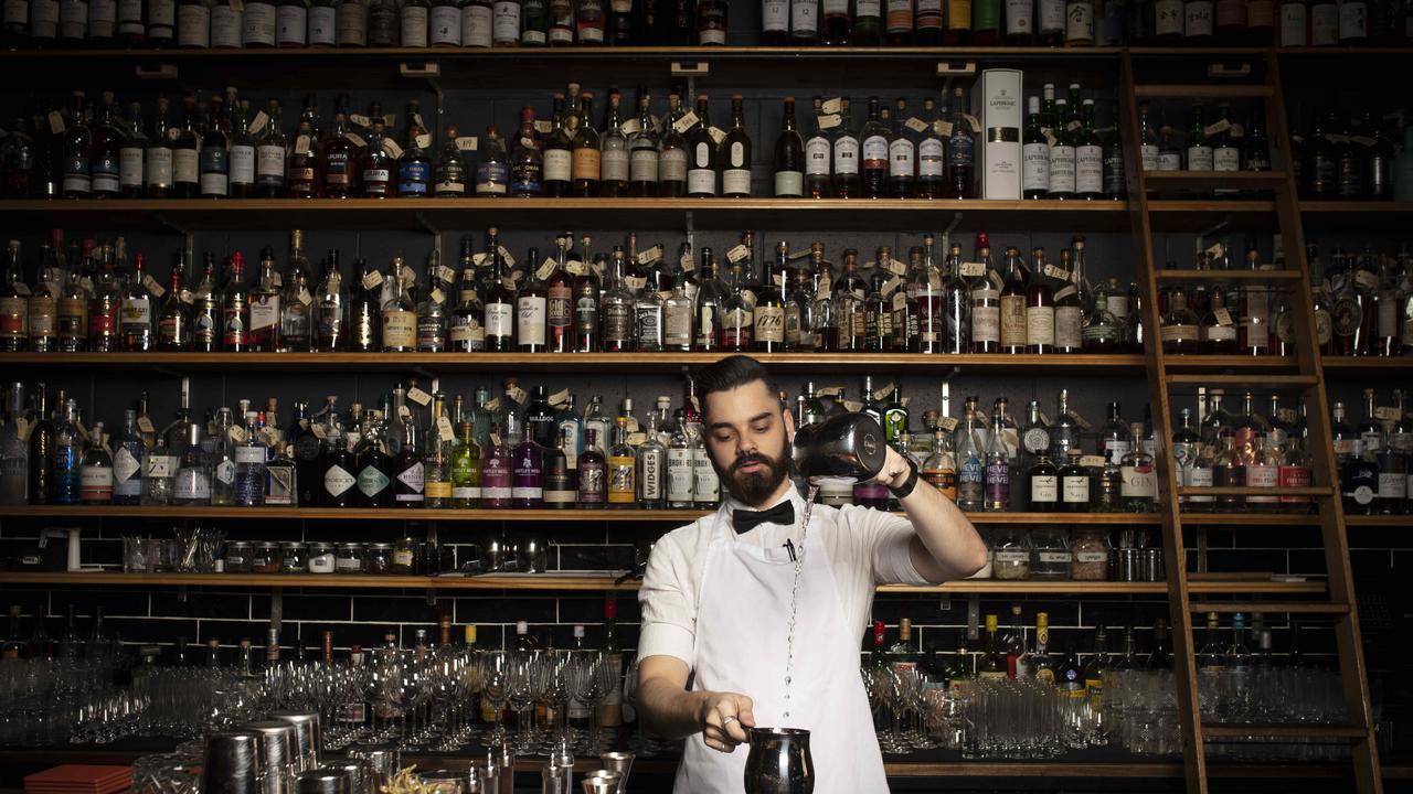 Bartender Joe Steadman at Death and Taxes in front of their impressive wall of alcohol. Picture: Russell Shakespeare