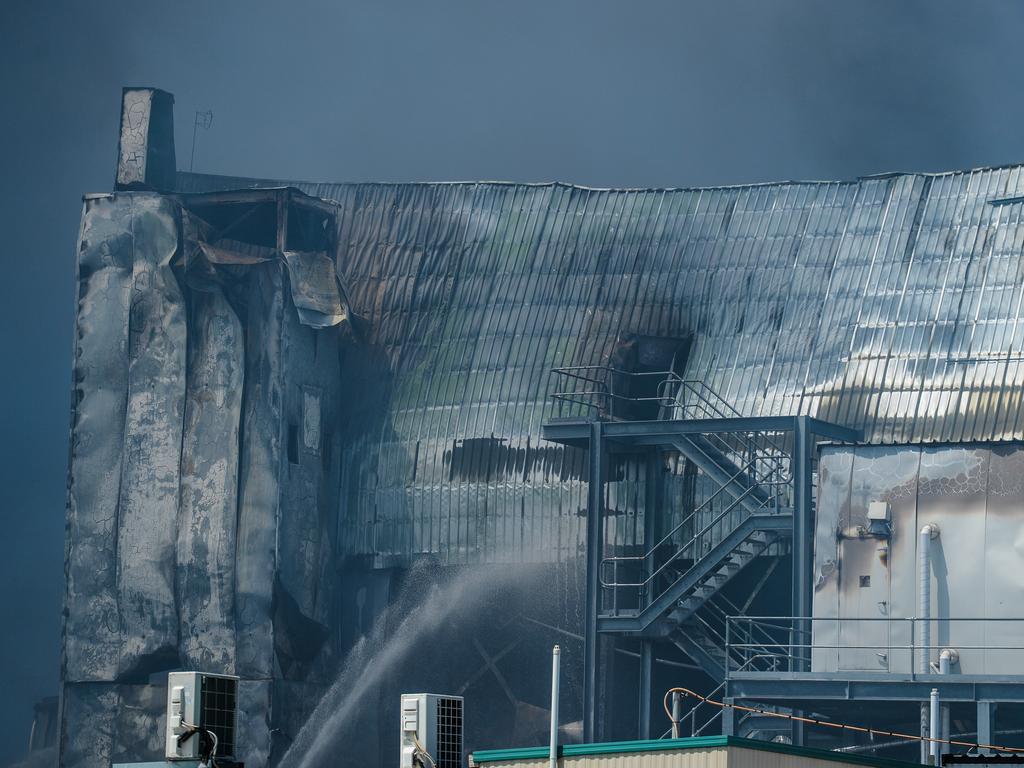 Emergency services continue to work on the huge fire at the Thomas Foods abattoir in Murray Bridge the morning after it broke out. Picture: AAP / Roy Vandervegt