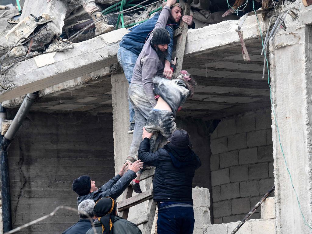 Residents retrieve an injured girl from the rubble of a collapsed building in the town of Jandaris, in the countryside of Syria's northwestern city of Afrin in the rebel-held part of Aleppo province. Picture: AFP